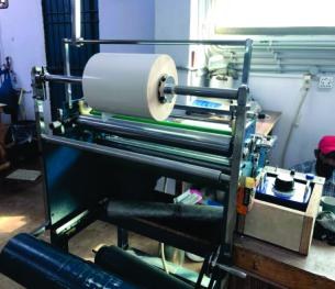 Roll converting machine with label material
